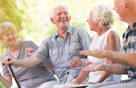 Four people are sitting on a bench, smiling and enjoying each other's company. AI generated content