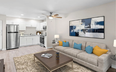 A large, clean, and empty living room with a couch, coffee table, and a refrigerator. AI generated content