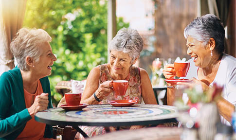 Three women are sitting at a table, enjoying coffee together. AI generated content