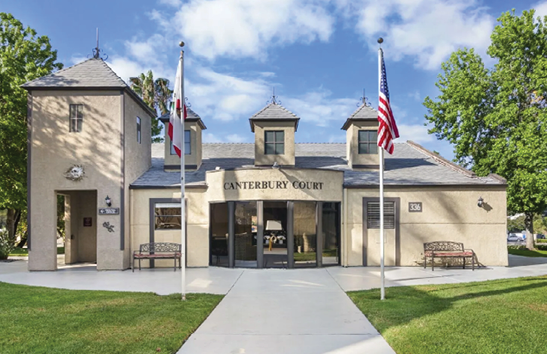 A courthouse with two flags on poles in front of it. AI generated content