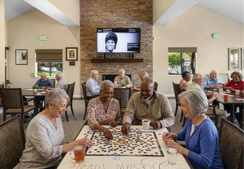 A group of elderly people are sitting around a table, smiling and enjoying their time together. They are holding green objects in their hands, possibly flowers or plants. The room is decorated with potted plants and vases, creating a pleasant atmosphere for the group. AI generated content